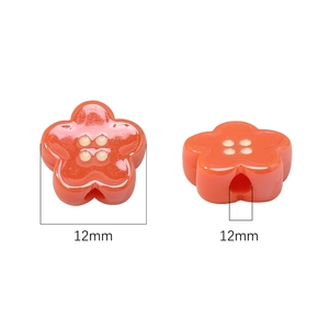 12mm orange acrylic flower bead with glossy finish and four yellow dots for jewelry making