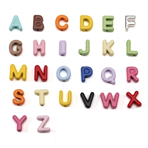 Close-up of 26 colorful alloy alphabet beads for DIY jewelry making with smooth finish
