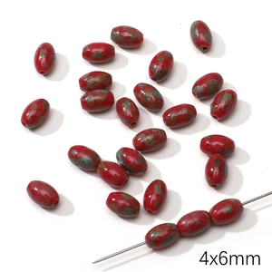 Detailed macro view of 4x6mm red mottled oval Czech glass beads for DIY jewelry making