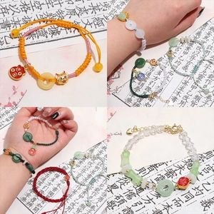 Detailed close-up of handmade zodiac charms and woven bracelets with Chinese lucky motifs