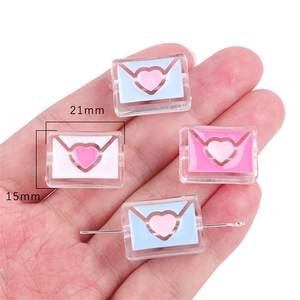 Detailed view of 21mm acrylic envelope beads with heart center for DIY jewelry making