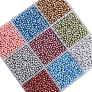 Detailed view of 4mm colorful glass pearls sorted in a clear nine-grid storage organizer box