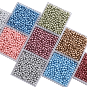 Macro view of 4mm colorful glass pearls and beads in a plastic storage box for DIY jewelry
