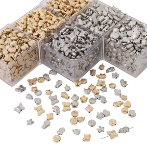 Detailed view of ocean-themed metal beads in storage boxes for DIY jewelry making