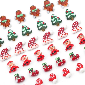 Handmade glass Christmas beads featuring gingerbread man, tree, and Santa for DIY jewelry
