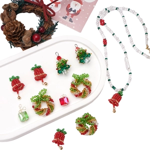 Detailed view of Christmas themed glass beaded charms like trees and wreaths for DIY jewelry