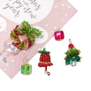 Handmade Christmas glass bead pendants featuring wreaths, trees, and crystal gift boxes
