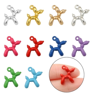 Macro view of colorful balloon dog charms showing various metallic finishes and size detail
