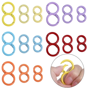 Detail of colorful S-shaped alloy carabiners in various sizes and spring clip mechanism