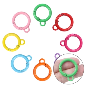 Close-up of 8 colorful alloy spring O-rings for DIY keychains and bag hardware