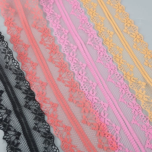 Detailed view of colorful polyester lace trims in black, coral, pink and yellow