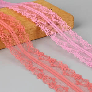 Detailed macro view of pink floral polyester lace trim for DIY earring and hair accessories