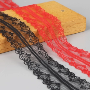 Detail of red and black polyester lace ribbon with scalloped edges for DIY crafts