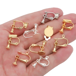Macro detail of various gold and silver screw-on ear clips and jewelry making accessories