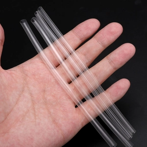 Two transparent PE heat shrink tubes for cable protection and insulation held in hand
