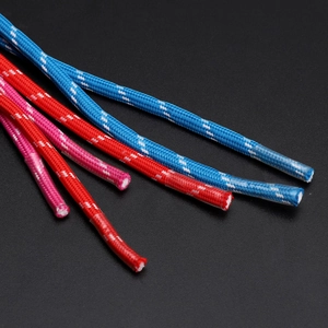 Close-up of flexible braided cable sleeves in blue, red, and pink with white patterns
