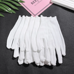 Close-up of stacked white cotton gloves for DIY jewelry making and precision work