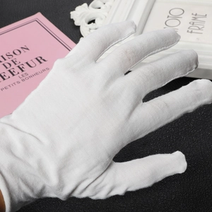 Close-up of white cotton protective gloves for jewelry handling and precision work