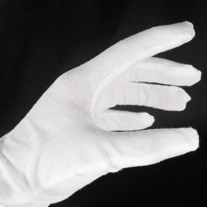 White cotton anti-oxidation gloves for jewelry making and precision handling on black