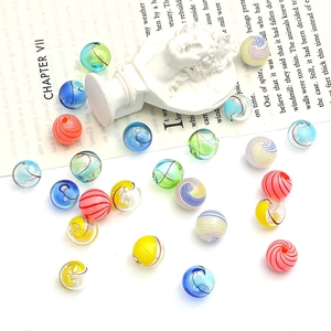 Macro shot of colorful striped hollow glass beads for DIY jewelry and necklace making
