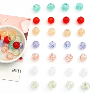 Macro view of multi-color spiral glass beads for DIY necklaces and handmade bracelets