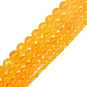 Macro shot of natural citrine beads showing internal ice cracks and translucent texture