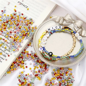 Colorful glass seed bead bracelet set with NICE and LIKE letters in a vintage tray