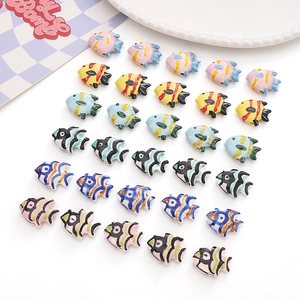 Macro detail of hand-painted tropical fish ceramic beads with colorful striped patterns
