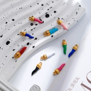 Macro shot of colorful cornicello charms with gold caps for DIY jewelry making