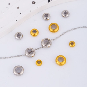 Close-up of gold and silver steel abacus spacer beads for DIY necklace adjustment