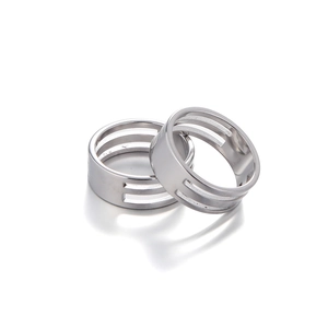 Close-up of a silver stainless steel jump ring opener tool with triple-loop design
