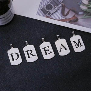 Detail van vijf roestvrijstalen letterhangers die DREAM vormen op een zwarte basis
