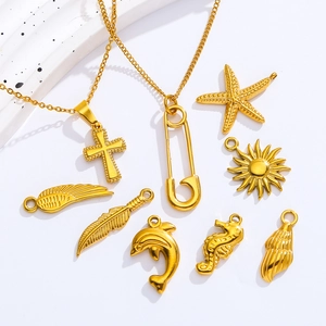 Detailed macro view of gold stainless steel ocean and religious themed DIY pendants