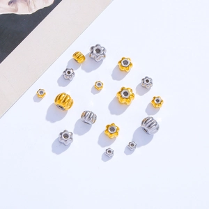 Macro detail of mixed gold and silver pumpkin beads and star spacers for DIY jewelry making