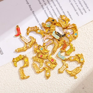 Detailed macro view of 18K gold-plated western cowboy boot charms with colorful enamel motifs
