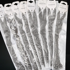 Set of stainless steel necklace chains in various styles with white tags on black background