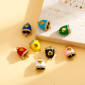 Macro detail of eight colorful enamel bell pendants with gold heart and crystal accents