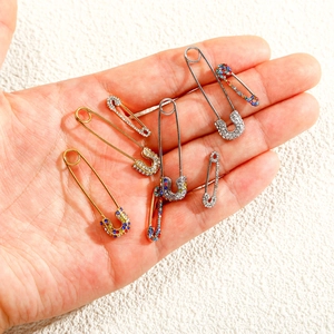 Polished gold and silver safety pins with sparkling colorful rhinestones accessories
