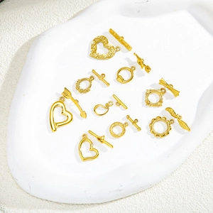 Golden stainless steel heart-shaped OT toggles and DIY jewelry connectors on a white base