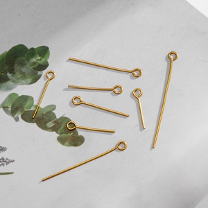 Macro view of gold plated stainless steel eye pins for DIY jewelry making in various lengths