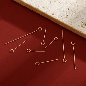 DIY jewelry 18K gold eye pins set on red background with decorative travertine stone