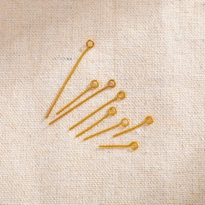 Golden stainless steel eye pins in various sizes for DIY jewelry and bead crafting
