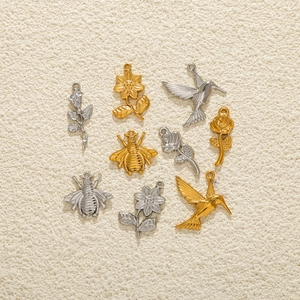 Detail of gold and silver stainless steel bee and flower charms for DIY jewelry making