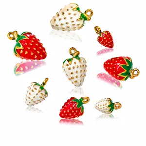 Detailed view of 3D solid strawberry charms in red and white enamel with gold dots