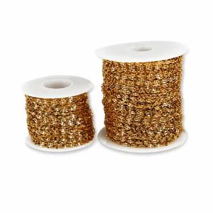 Close-up of golden stainless steel lip and butterfly chains on spools for jewelry making