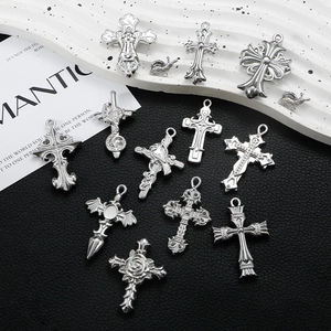 Macro shot of vintage silver stainless steel cross pendants and gothic jewelry accessories