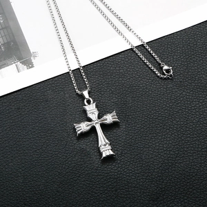 Macro shot of gothic cross pendant with intricate texture and durable box chain