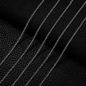 Multiple 2mm stainless steel pearl chain links for DIY jewelry on black leather
