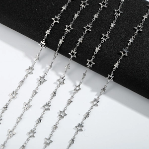 Polished 304L stainless steel star link chain necklaces arranged on black and white background