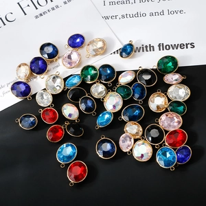 Detailed view of colorful oval faceted glass pendants with gold plated stainless steel edges